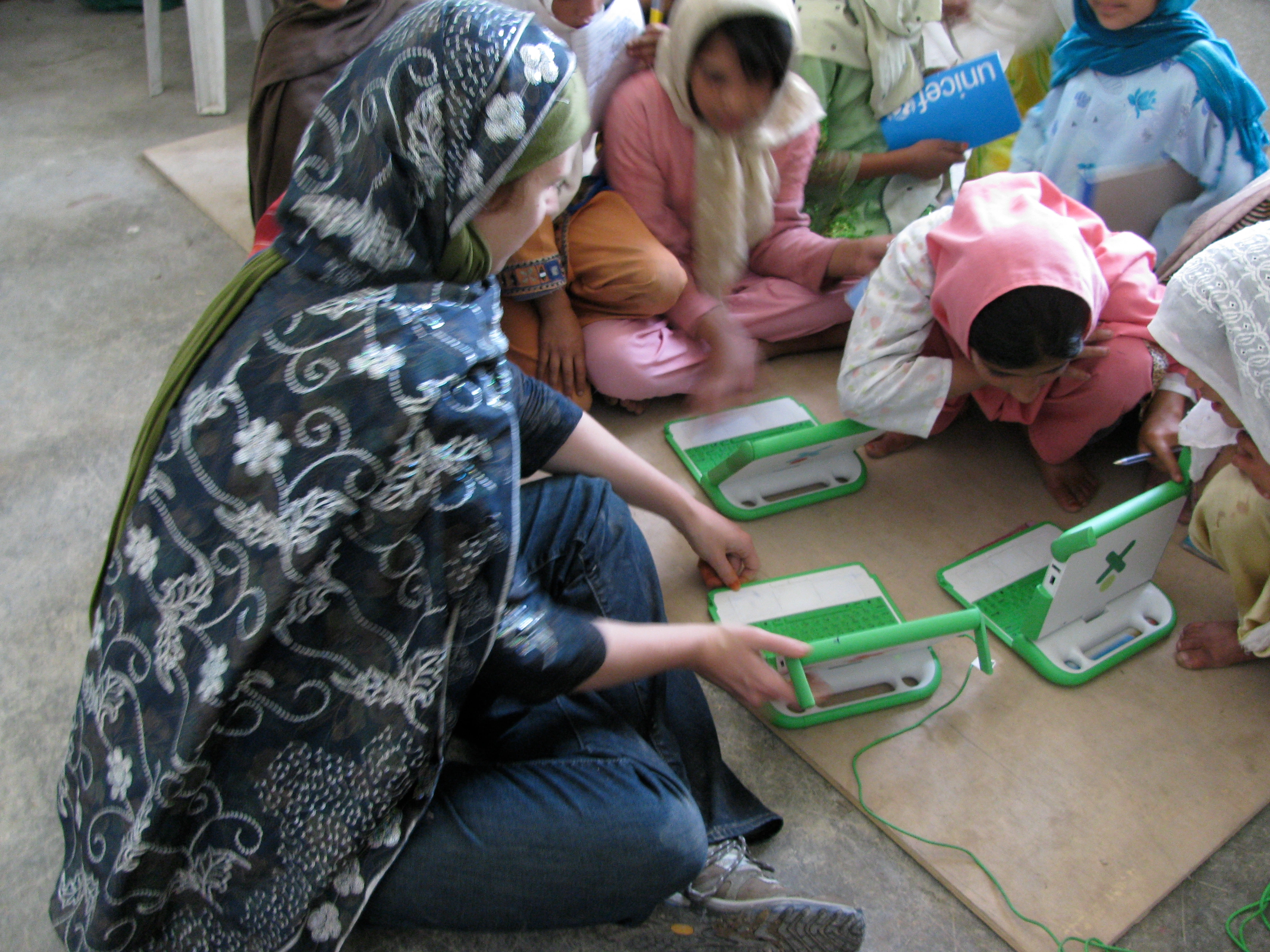 Afghan girls learning to use laptops during a computer lesson in 2009