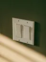 Two light switches in warm afternoon light