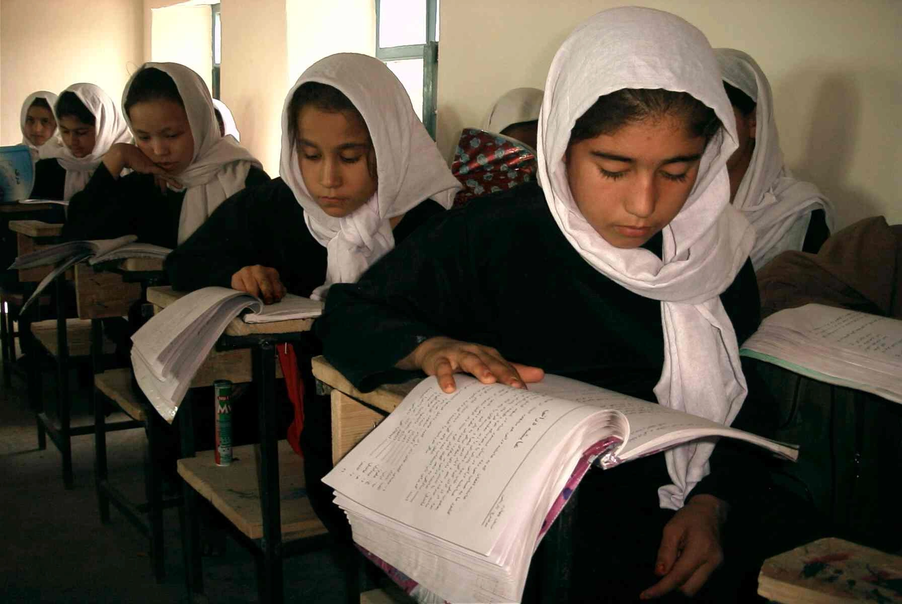 Girls reading at their desks at a school in Samangan, Afghanistan, in 2006